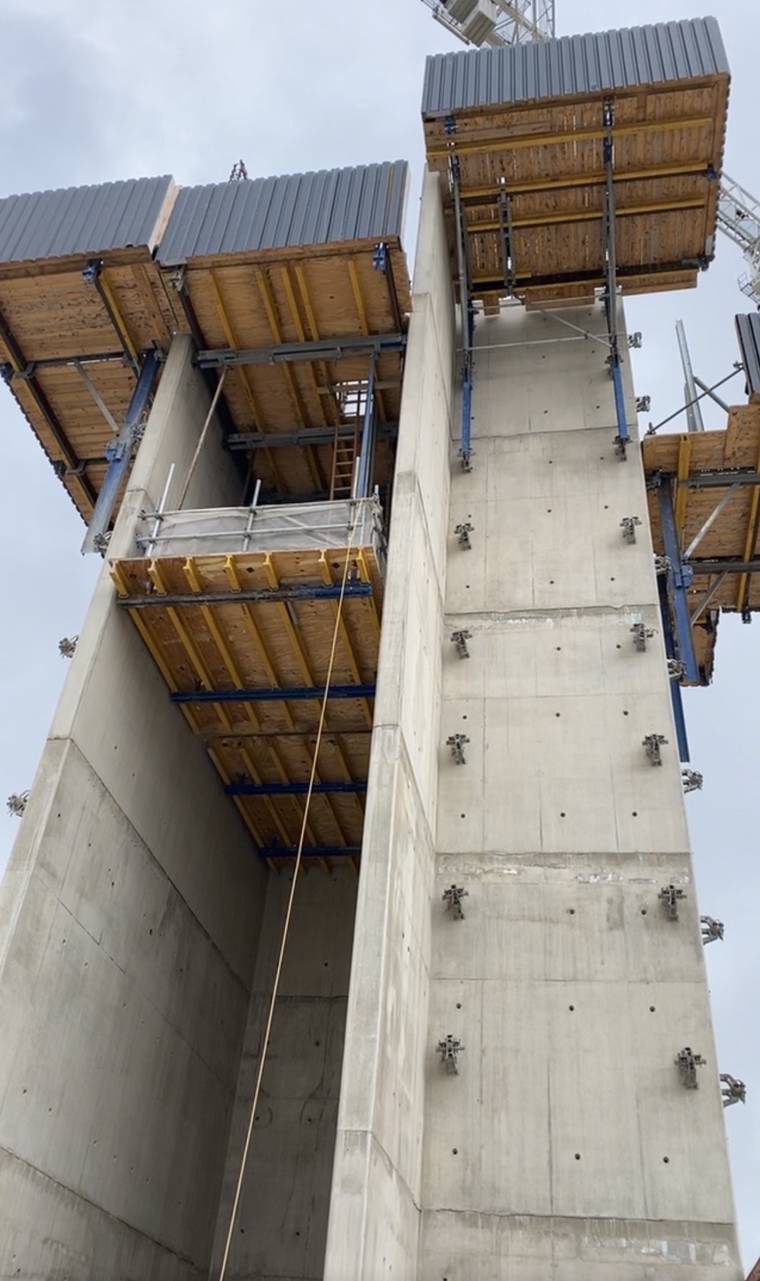 Looking up an in-situ concrete core with climbing formwork brackets, soffit tables and wall panels set for the next lift.