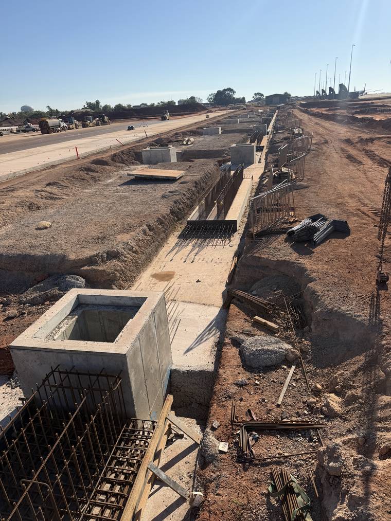 Poured and finished pit lid slab with the supporting formwork and props visible below.