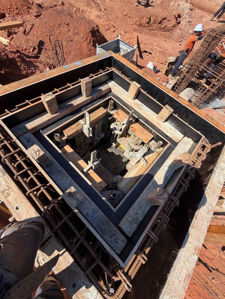 View down into a shuttered pit showing internal forms, props and fixed reinforcement.