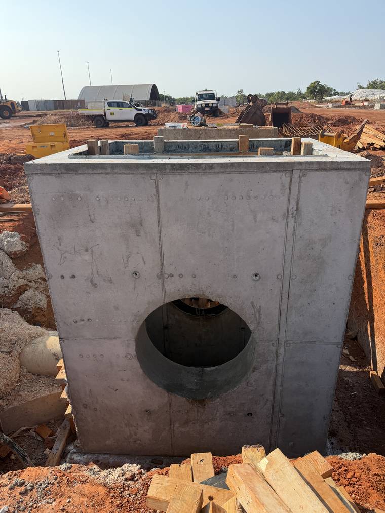 Completed stormwater pit with a formed circular pipe penetration through the wall face.