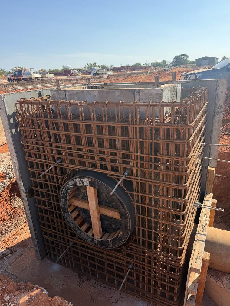Reinforcement cage fixed around a stormwater pit ahead of the wall pour.
