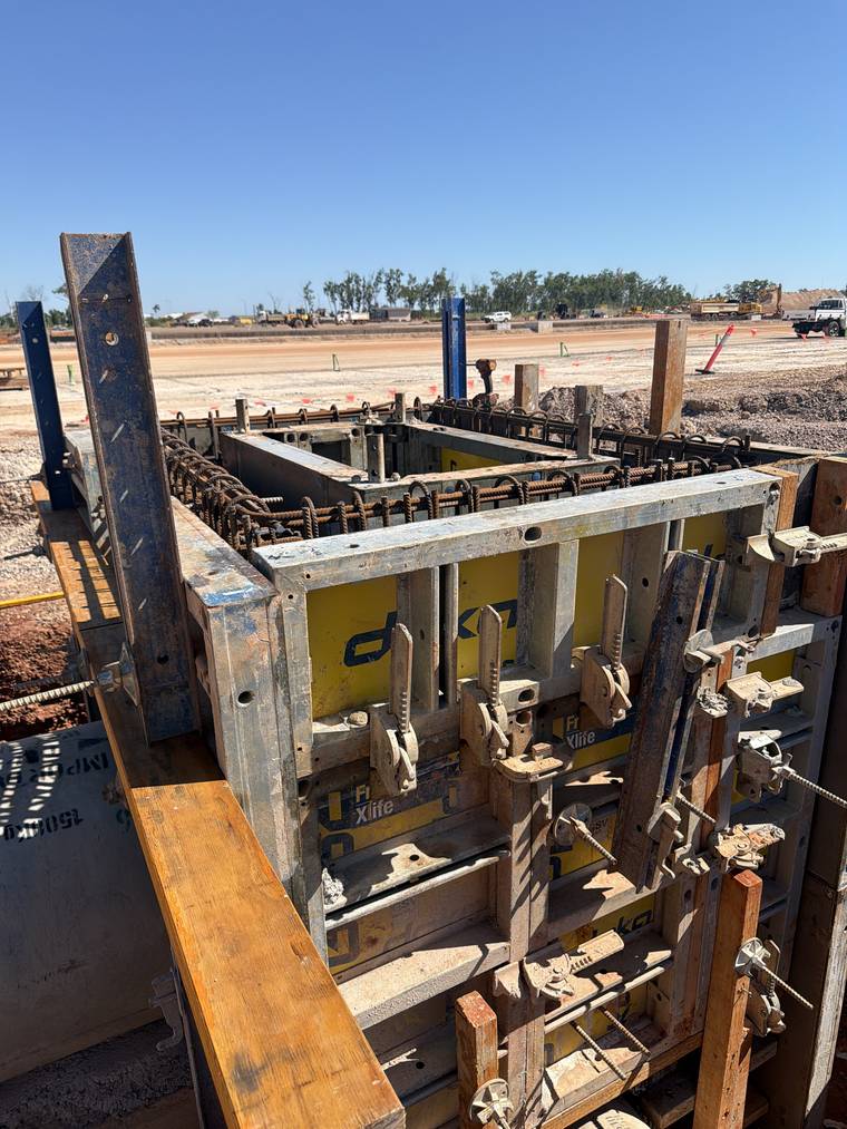 Proprietary system formwork panels aligned and clamped together to form a pit wall.