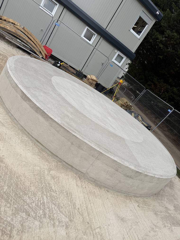 Low-angle view of the finished plinth showing a consistent arris and face around the radius.