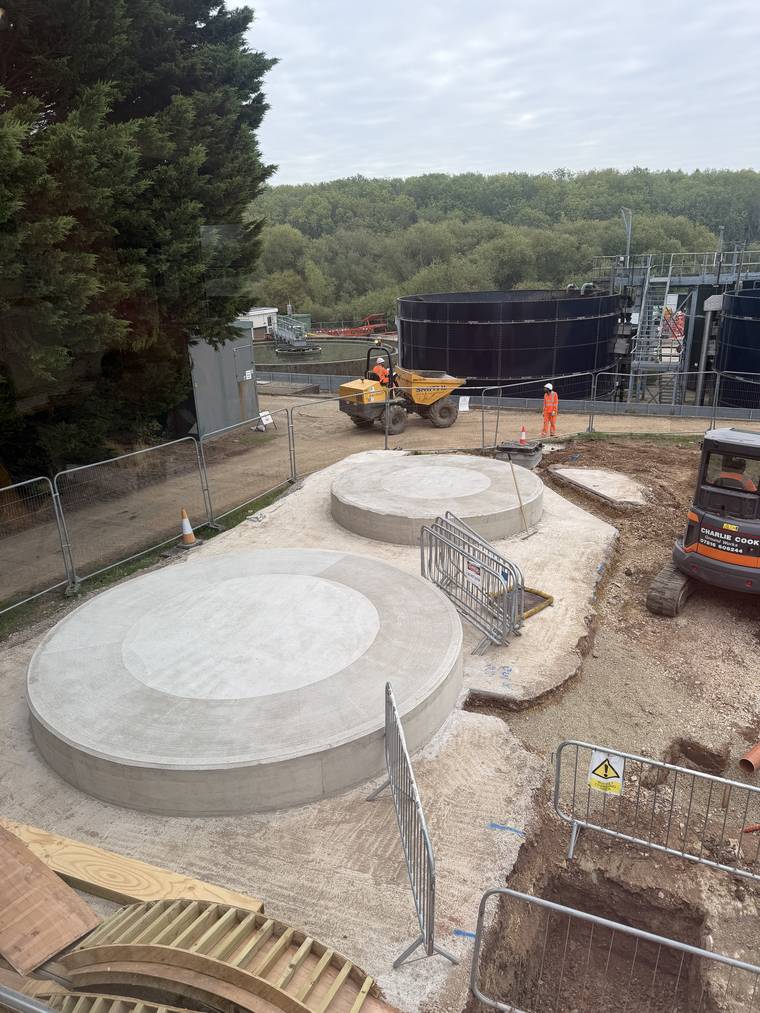 Both completed circular plinths in position on site next to existing water treatment tanks.