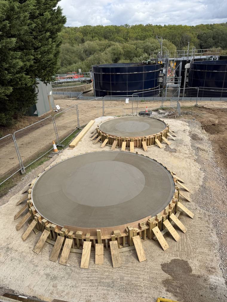 Circular plinths poured and floated with the timber forms still in place.