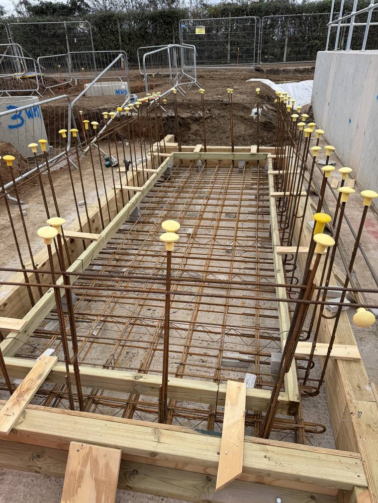 Timber edge shuttering and fixed reinforcement to a motor control centre base slab before pouring.